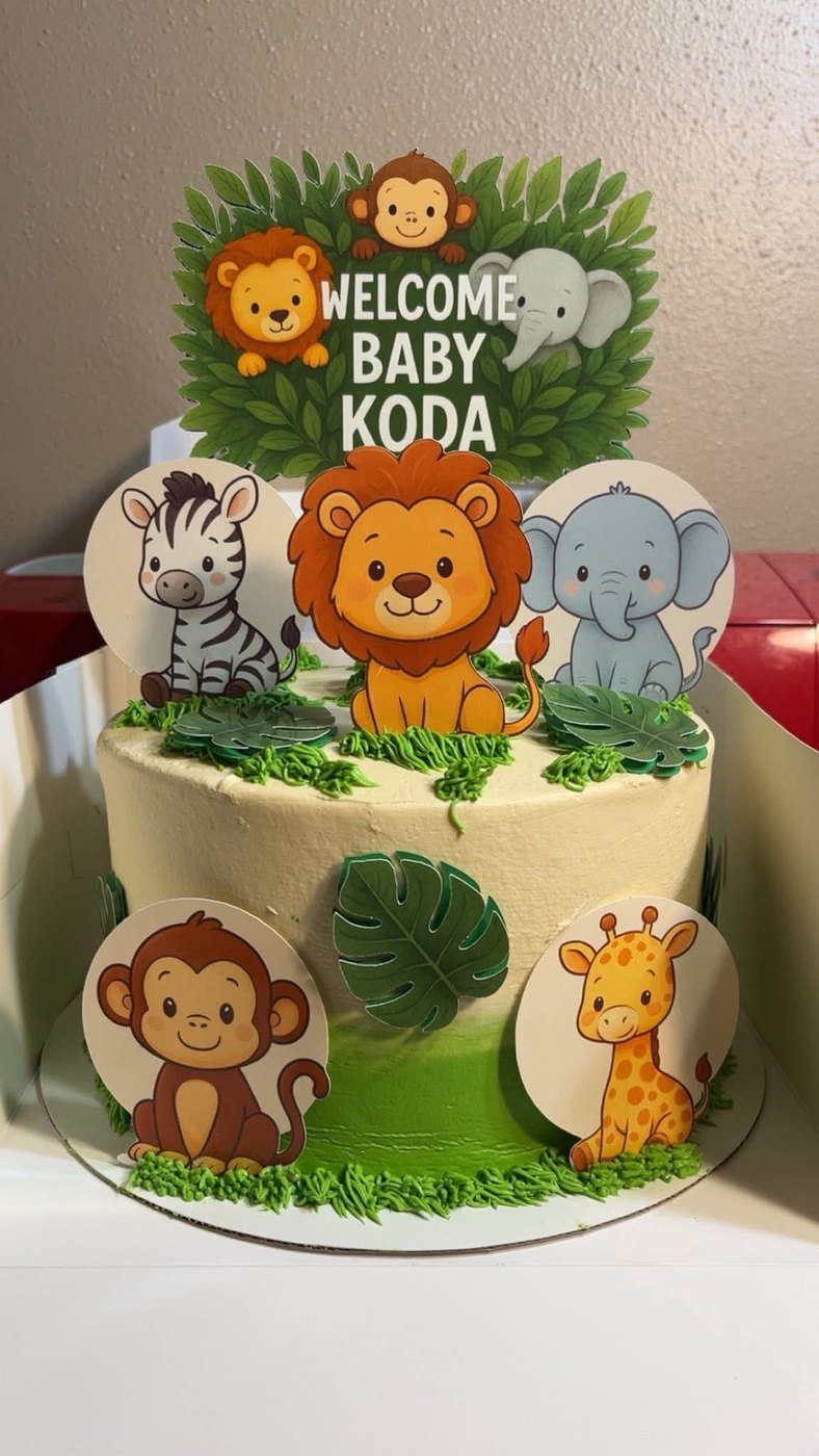 Jungle animal baby shower cake with a Welcome Baby Koda topper